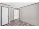 Bedroom with wood-look flooring featuring two entryways and neutral colored walls at 8426 Sweden Blvd, Punta Gorda, FL 33982