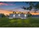Exterior view of the home with a vibrant sunset sky in the background at 8426 Sweden Blvd, Punta Gorda, FL 33982