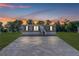 Charming home with a gravel driveway, well maintained lawn, and freshly painted siding at dusk at 8426 Sweden Blvd, Punta Gorda, FL 33982
