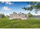 Exterior view of the home featuring a well-maintained lawn and charming entrance at 8426 Sweden Blvd, Punta Gorda, FL 33982
