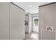 Hallway leading to the kitchen with stainless appliances and white door at 8426 Sweden Blvd, Punta Gorda, FL 33982