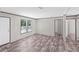 Bright living room with windows, luxury vinyl flooring, and white painted door and trim at 8426 Sweden Blvd, Punta Gorda, FL 33982