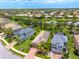 An aerial view shows this property with a well-manicured lawn surrounded by mature trees at 8437 Nandina Dr, Sarasota, FL 34240