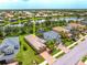 Aerial view of the home with well-kept lawn in a lakeside community with lush landscaping at 8437 Nandina Dr, Sarasota, FL 34240