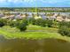 Overhead view showcasing the backyard, lake views, lush trees, and the home's location at 8437 Nandina Dr, Sarasota, FL 34240