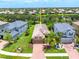 Aerial view of the property with a manicured lawn, brick driveway, and tranquil community at 8437 Nandina Dr, Sarasota, FL 34240