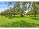Lush green backyard with mature trees, offering a tranquil and private outdoor space at 8437 Nandina Dr, Sarasota, FL 34240