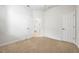 Bedroom with neutral carpet, closet, ceiling fan, and open door to the bathroom at 8437 Nandina Dr, Sarasota, FL 34240