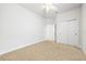 A carpeted bedroom with ceiling fan and closet for a comfortable and functional space at 8437 Nandina Dr, Sarasota, FL 34240
