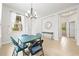 Bright dining area with tile flooring, chandelier, and natural light from large windows at 8437 Nandina Dr, Sarasota, FL 34240