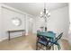 Dining room featuring tile floors, a modern chandelier, and lots of natural light at 8437 Nandina Dr, Sarasota, FL 34240