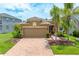 Attractive home boasting a brick driveway, manicured landscaping, and a welcoming facade at 8437 Nandina Dr, Sarasota, FL 34240