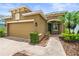 Charming single-story home showcasing a brick driveway, a two-car garage, and lush landscaping at 8437 Nandina Dr, Sarasota, FL 34240