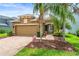 Inviting home featuring a two-car garage, mature landscaping, and a paver walkway to the covered front entry at 8437 Nandina Dr, Sarasota, FL 34240