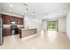 Open-concept kitchen and living area featuring an island with pendant lighting and sliding doors at 8437 Nandina Dr, Sarasota, FL 34240