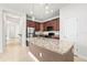 Well-lit kitchen featuring an island with pendant lights, stainless appliances, and stone countertops at 8437 Nandina Dr, Sarasota, FL 34240