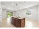 Kitchen island with stainless steel dishwasher and sink, granite countertop in an open-concept living space at 8437 Nandina Dr, Sarasota, FL 34240