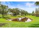 The community features a scenic pond surrounded by lush greenery, perfect for enjoying nature at 8437 Nandina Dr, Sarasota, FL 34240