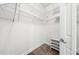 An organized walk-in closet with metal racks and a small shoe rack in a clean, bright space at 8437 Nandina Dr, Sarasota, FL 34240
