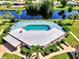 Scenic aerial view of the community, featuring the pool and canal, with mature landscaping and neighborhood views at 96 Boundary Blvd # 127, Rotonda West, FL 33947