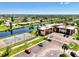 Aerial view of the community buildings, parking, and canal, showcasing easy access to local amenities at 96 Boundary Blvd # 127, Rotonda West, FL 33947