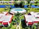 Aerial view of the community, showing the pool, green spaces, and canal, perfect for relaxation and recreation at 96 Boundary Blvd # 127, Rotonda West, FL 33947