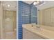 Bright bathroom featuring a shower and vanity with a sink at 96 Boundary Blvd # 127, Rotonda West, FL 33947