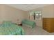 Cozy bedroom features two twin beds, light wood floors, and sunny window views at 96 Boundary Blvd # 127, Rotonda West, FL 33947