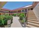 Charming courtyard view with well-maintained landscaping, flowers and multi-story buildings at 96 Boundary Blvd # 127, Rotonda West, FL 33947