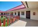 Exterior hallway view with chairs, planters, and red railings at 96 Boundary Blvd # 127, Rotonda West, FL 33947