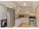Bright kitchen features stainless steel appliances and granite countertops at 96 Boundary Blvd # 127, Rotonda West, FL 33947