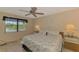 The bedroom features a ceiling fan and bright natural lighting at 96 Boundary Blvd # 127, Rotonda West, FL 33947