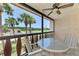 Inviting screened patio features a table and chairs, perfect for enjoying the outdoors at 96 Boundary Blvd # 127, Rotonda West, FL 33947