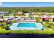 Aerial view of a community pool surrounded by buildings, parking, and landscaping at 96 Boundary Blvd # 127, Rotonda West, FL 33947