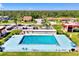 Aerial view of community pool with ample parking and adjacent buildings at 96 Boundary Blvd # 127, Rotonda West, FL 33947