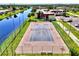 Aerial view of the community tennis court, located next to the canal and walking paths for easy access at 96 Boundary Blvd # 127, Rotonda West, FL 33947