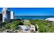Scenic aerial view of coastal buildings and bay, highlighting green spaces and waterfront amenities at 988 Blvd Of The Arts # 1016, Sarasota, FL 34236