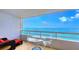 Private balcony overlooking beautiful bay views, furnished with comfortable lounge chairs at 988 Blvd Of The Arts # 1016, Sarasota, FL 34236