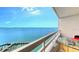 Balcony overlooking beautiful bay views with modern, clear furniture at 988 Blvd Of The Arts # 1016, Sarasota, FL 34236