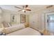 Bedroom with two twin beds, nautical decor, ceiling fan and minimalist design at 988 Blvd Of The Arts # 1016, Sarasota, FL 34236