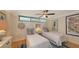 Bedroom with two twin beds, nautical decor, ceiling fan and minimalist design at 988 Blvd Of The Arts # 1016, Sarasota, FL 34236
