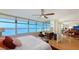 Bedroom boasts expansive bay views, mirrored wall and workstation with desk at 988 Blvd Of The Arts # 1016, Sarasota, FL 34236