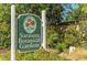 Entrance sign to Sarasota Botanical Gardens set amidst lush landscaping, inviting exploration and discovery at 988 Blvd Of The Arts # 1016, Sarasota, FL 34236