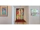 Hallway featuring colorful artwork on the walls and an accent bench at 988 Blvd Of The Arts # 1016, Sarasota, FL 34236