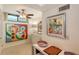 Bright hallway features modern art, a ceiling fan and tile floors at 988 Blvd Of The Arts # 1016, Sarasota, FL 34236