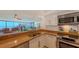 This bright kitchen features white cabinets, stainless appliances and open concept to the living room at 988 Blvd Of The Arts # 1016, Sarasota, FL 34236