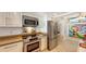 Well-lit kitchen features stainless appliances, white cabinetry, and beautiful countertops at 988 Blvd Of The Arts # 1016, Sarasota, FL 34236