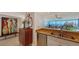 View of the kitchen leading into the living and dining area with beautiful bay views at 988 Blvd Of The Arts # 1016, Sarasota, FL 34236
