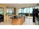 Eat-in kitchen with granite countertops, a kitchen island and an ocean view at 988 Blvd Of The Arts # 1016, Sarasota, FL 34236