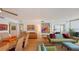 Bright living area with hardwood floors, stylish furnishings, and seamless access to the balcony at 988 Blvd Of The Arts # 1016, Sarasota, FL 34236